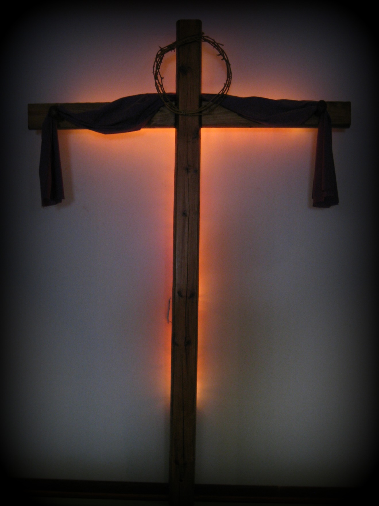Cross behind our pulpit in the church building.